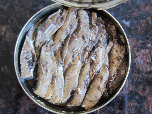 opened can of smoked sprats in oil